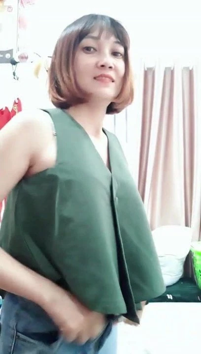 Vietnamese girl finishing getting dressed